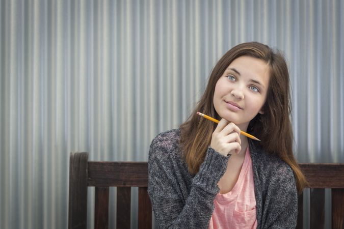 Daydreaming Female Student With Pencil Looking to the Side