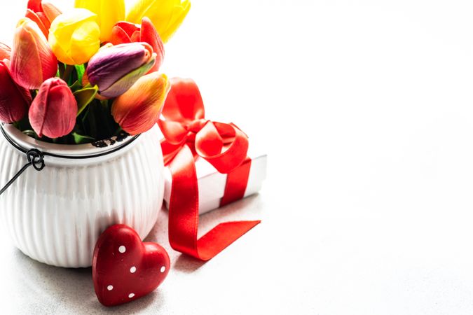 Small vase of tulips and dotted heart ornaments