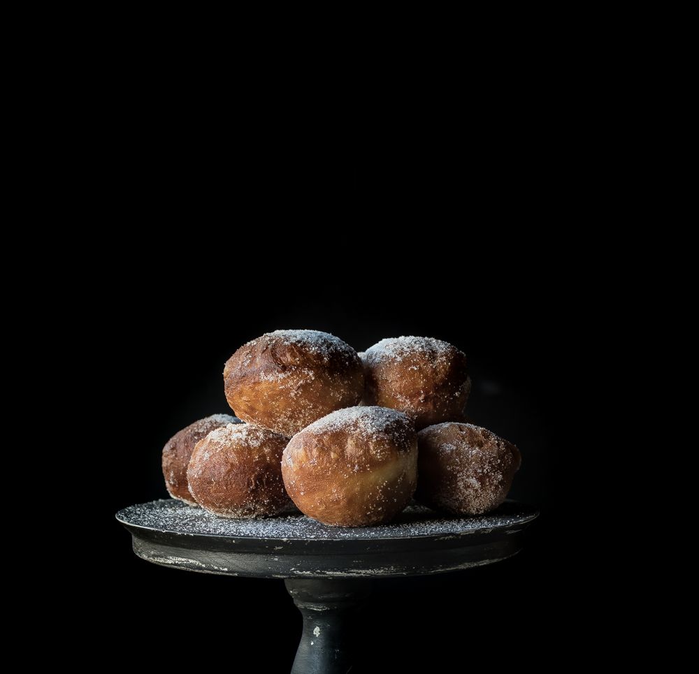 Baked cakes on stand on table
