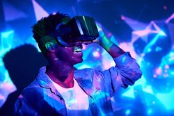 Expressive Black man in VR headset in neon lights