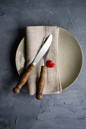 Table setting with beige ceramic plate and heart decoration