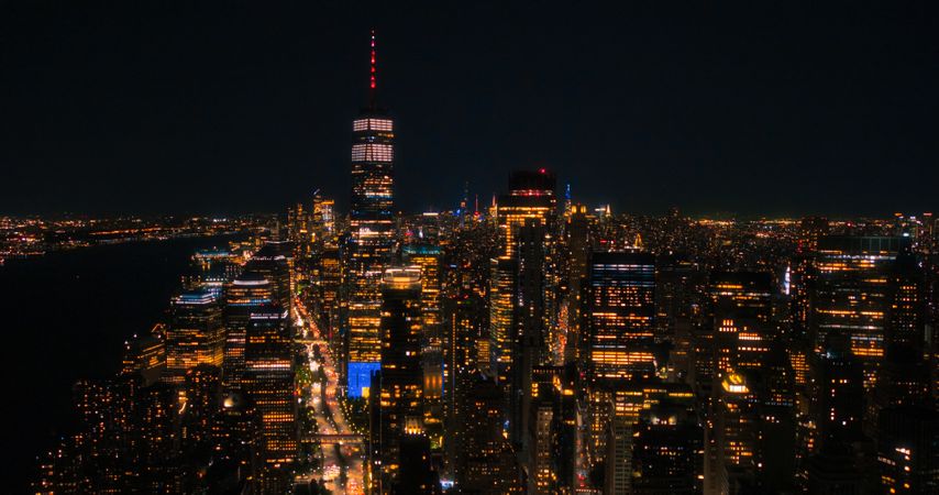 Night Aerial Photo with the One World Trade Center Skyscraper with Lights in Office Rooms Inside. Helicopter Flying Close to the Building with a View on New York City