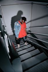 Stylish Black man standing on staircase