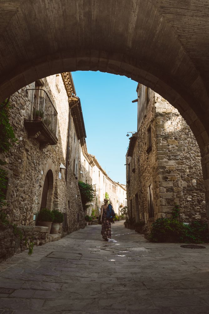 Woman walking in a narrow path in a village