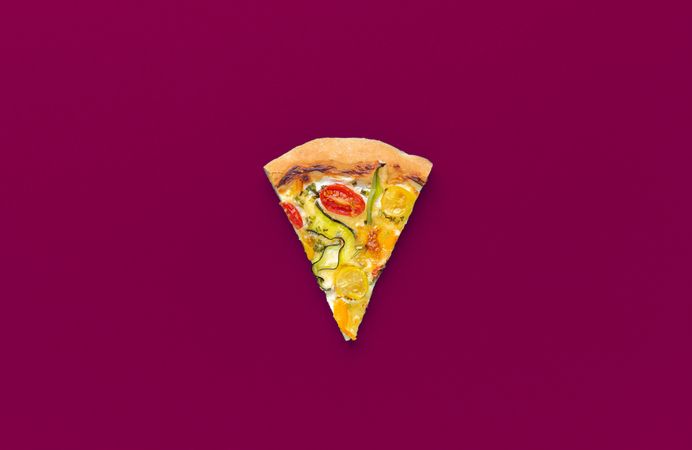 Vegetarian pizza slice isolated on a magenta background