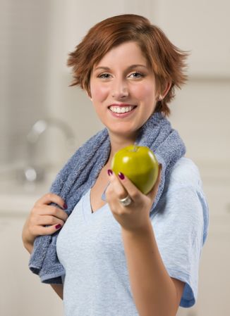 Red Haired Woman with Towel Holding Green Apple