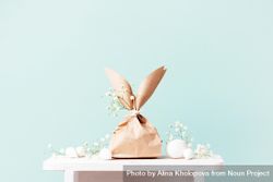 Two paper bags in Easter bunny shapes on table on blue background 4A7jm0