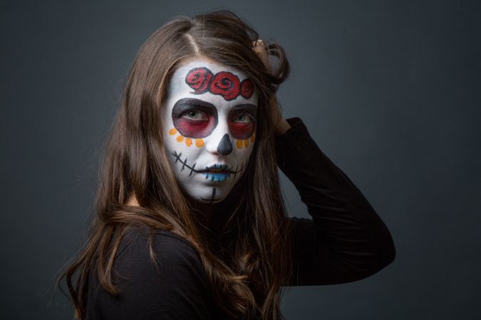 Young woman with creepy face paint