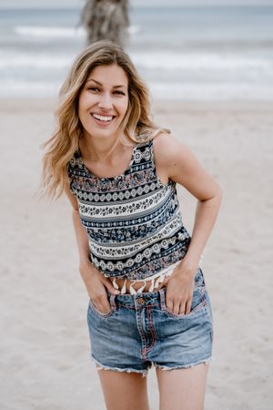Happy female laughing on sandy beach