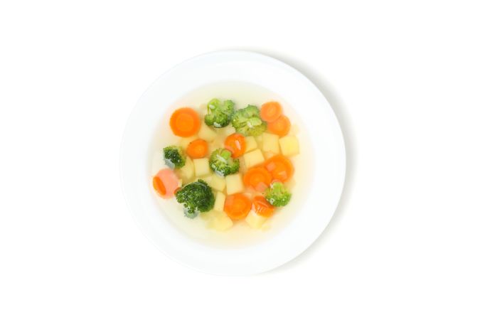 Lookin down at vegetable soup in blank studio shoot
