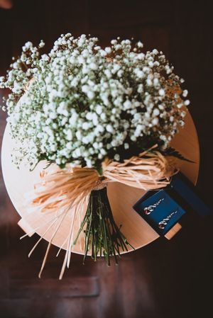 Bouquet of white flowers and earrings on stand