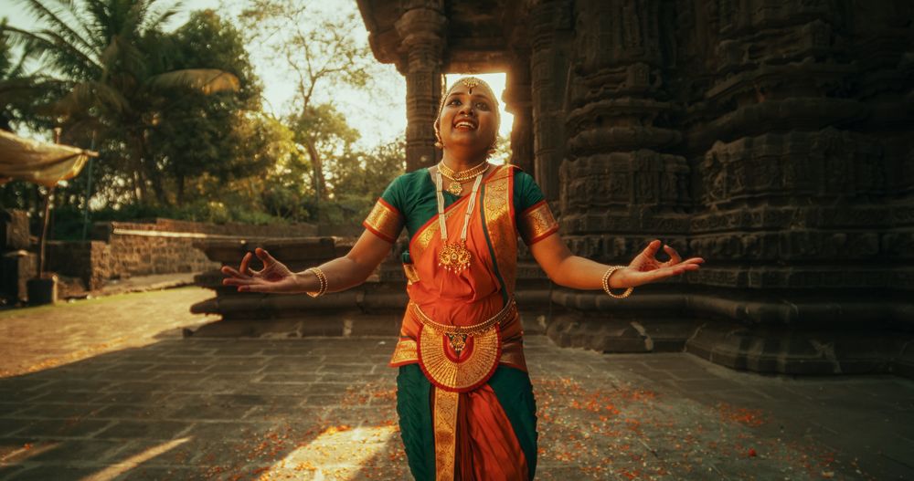 Dynamic Shot of Indian Women in Traditional Clothes Dancing Bharatanatyam in Colourful Sari