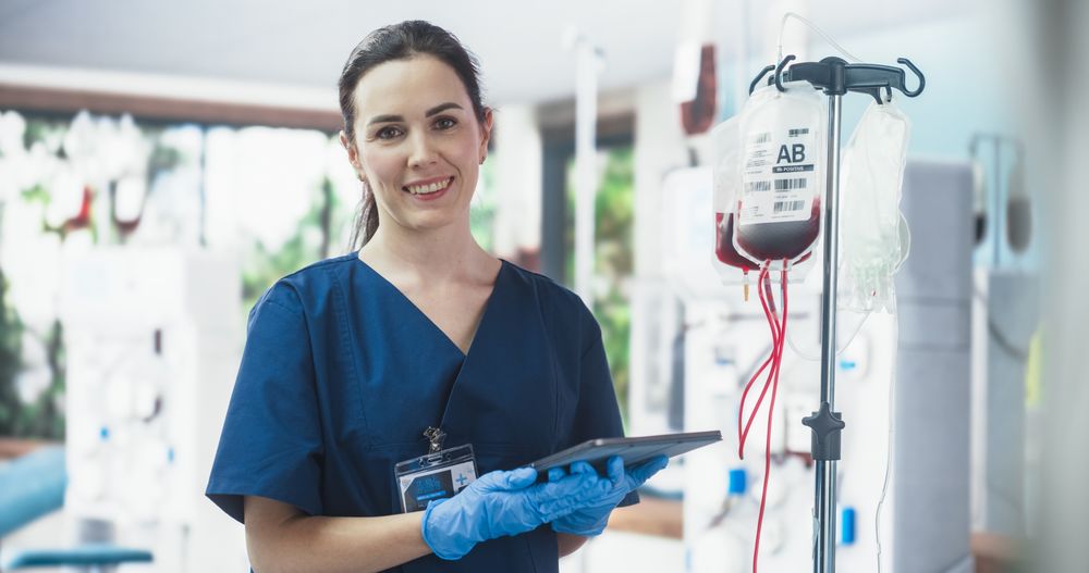 Professional Woman Looks At The Camera And Smiling Cheerfully Inviting Donors To Save Lives.