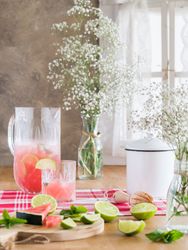 Jar of refreshing watermelon beverage with lime in kitchen
