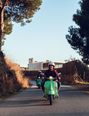 Young people riding motorcycles on city road