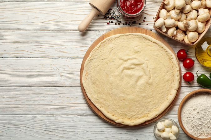 Concept for cooking pizza with ingredients on wooden table