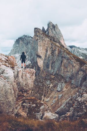 Man standing on rock formation mountain in Dolomites, Italy