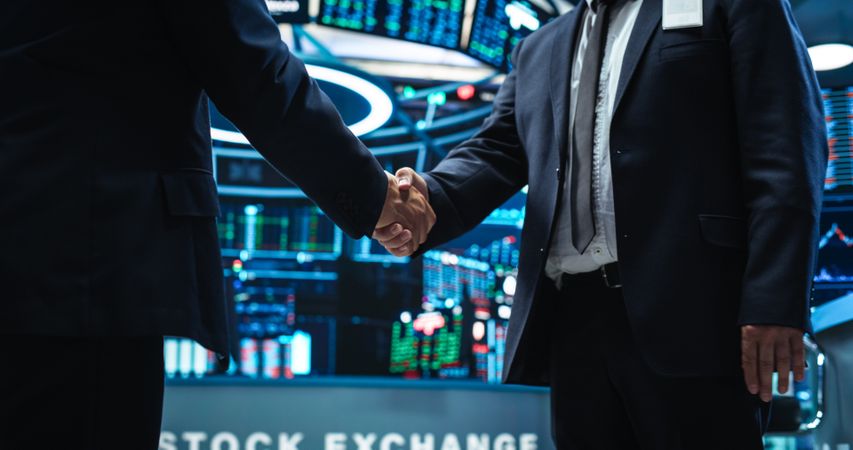 Two Corporate Business Partners Agree on Successful Deal, Shake Hand in Office.