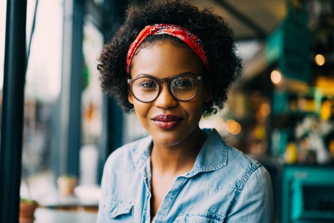 Portrait of Black woman in glasses and denim shirt