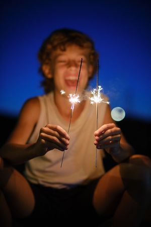 Glad boy with glowing Bengal lights