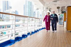 Happy Older Couple Walking The Deck of a Luxury Passenger Cruise Ship.