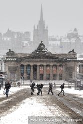 People walking on street near building in Edinburgh University campus while snowing 5lrw7b