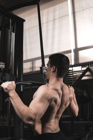 Young fitness man training in gym