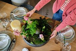Crop woman serving table for dinner