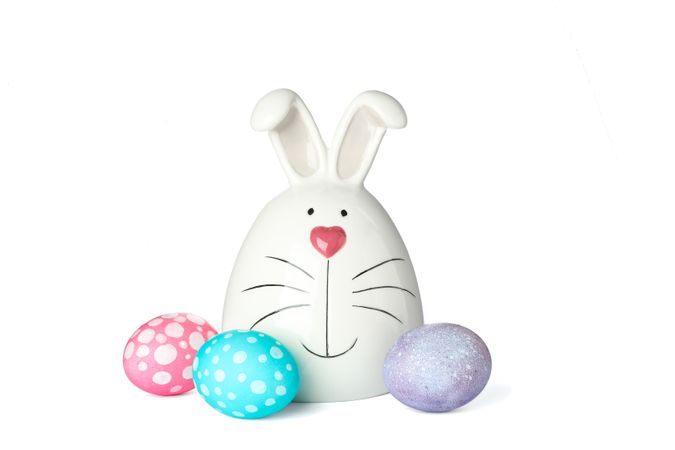 Decorated bunny and Easter eggs isolated on plain background. Festive tradition