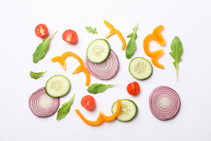 Fresh vegetables slices on blank background, top view
