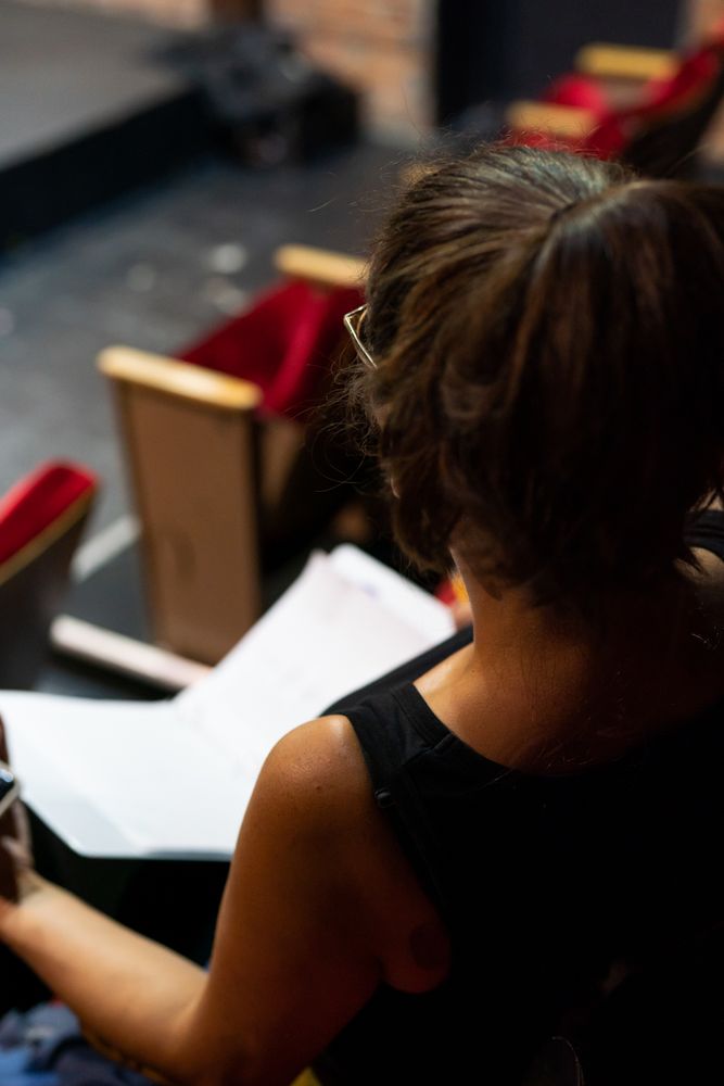 Over the shoulder shot of female director sitting in theater