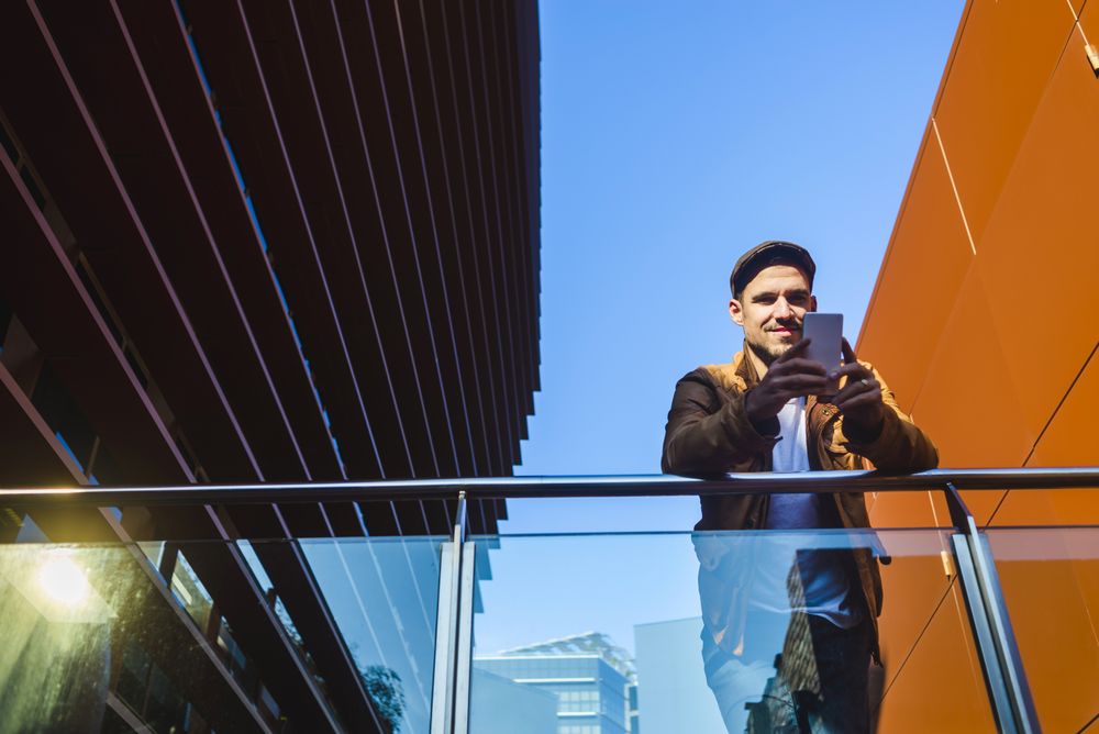 Man using mobile phone in modern building