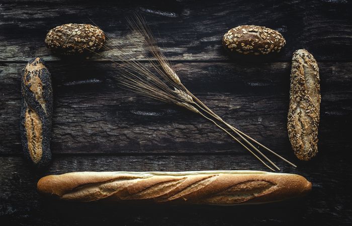 Assorted gold homemade bread on dark wood background