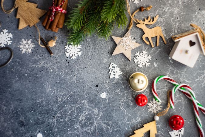 Christmas decorations and fir scattered on marble table