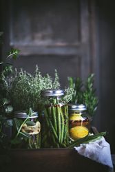 Fresh green vegetables with fruits and glass jars