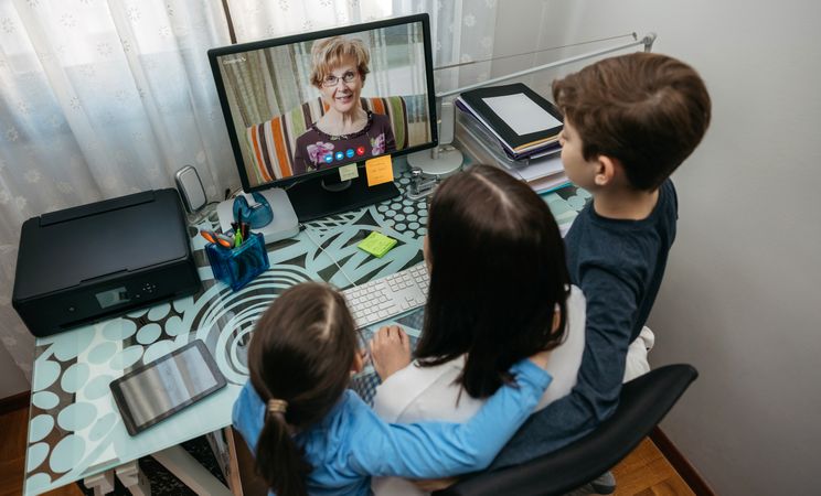 Family talking on video call with grandmother