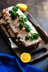 Mint garnish of freshly baked lemon cake dessert with icing and lemon slices