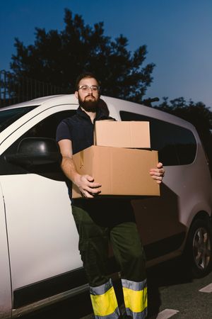Dedicated upset courier with cartons waiting client for delivery completion