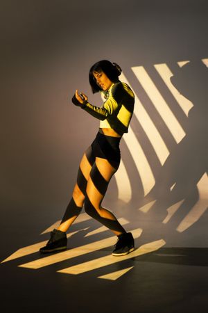 Sensual woman dancing under bright light