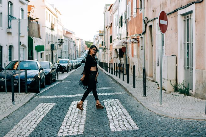 Joyful trendy female in old town street