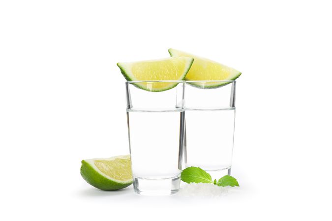 Tequila shots, lime, mint and salt isolated on blank background