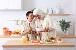 Mom and Kids Preparing ketupat Lebaran for Eid Al Fitr Celebration
