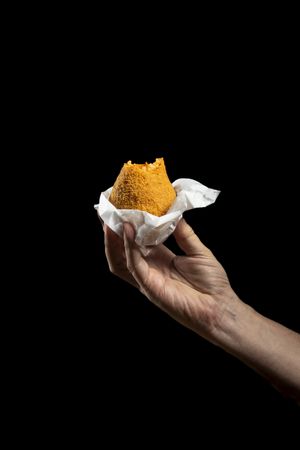 Bitten Sicilian Arancino with visible rice and ragu filling