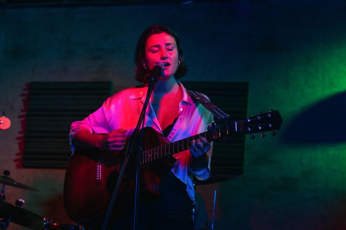 Musicians In Stage With Colorful Lights Performing In A Live Concert