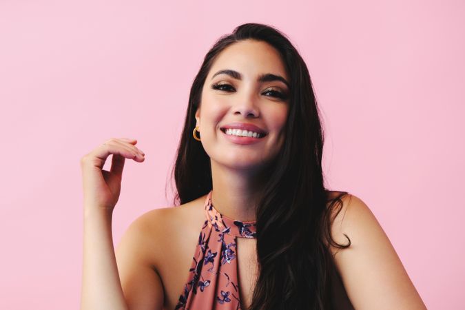Smiling Hispanic woman with in pink room