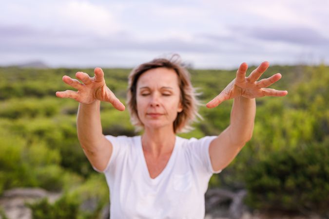 Adult woman practicing martial arts in nature