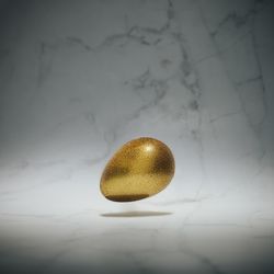 Gold egg on marble background