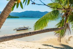 Boat on shallow of sandy sea shore