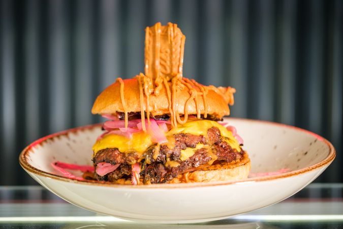 Appetizing hamburger on plate in cafe