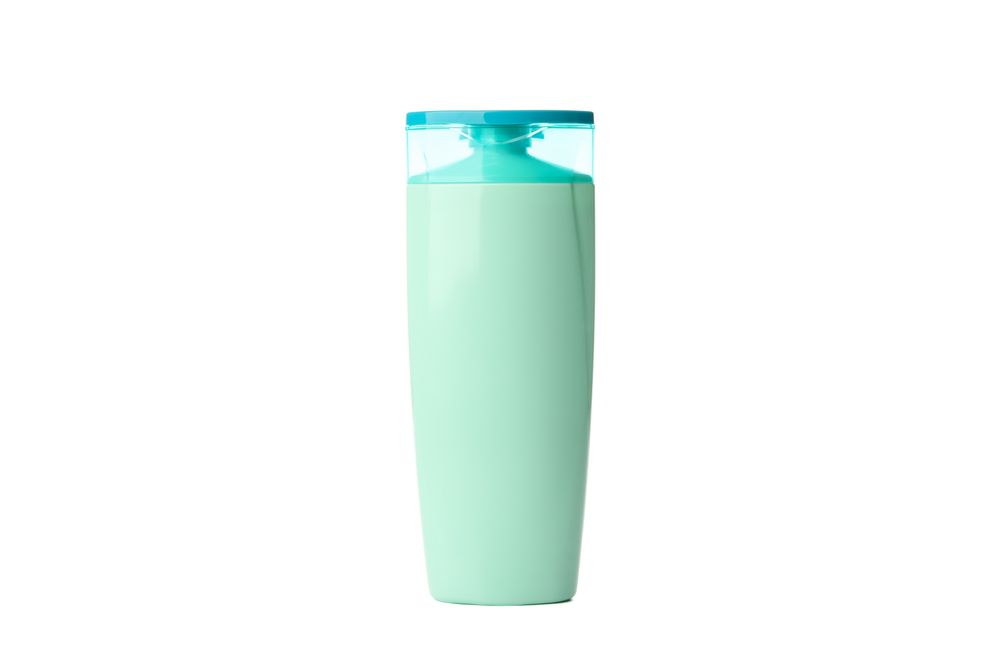 Blank plastic shampoo or lotion bottle isolated on light background